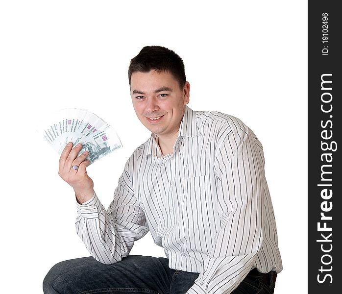 Happy young man holding a money in the form of a fan on a white background