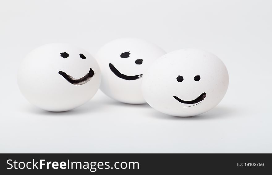 three white smiling egg closeup