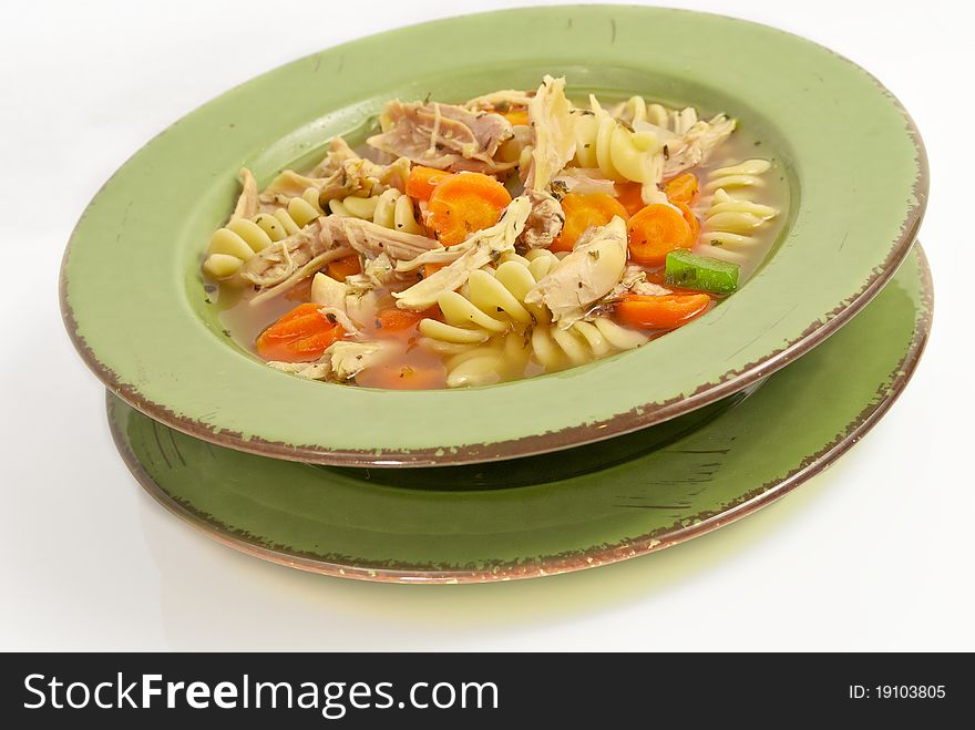 Home made chicken noodle soup served in a bowl. Home made chicken noodle soup served in a bowl