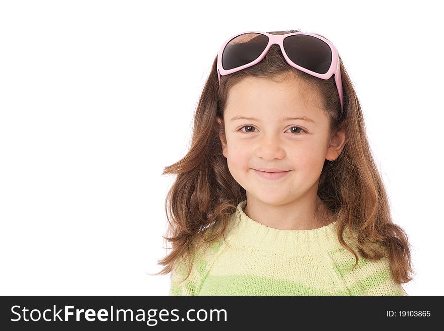 Young girl with sunglasses on head and wearing green striped jumper and smiling