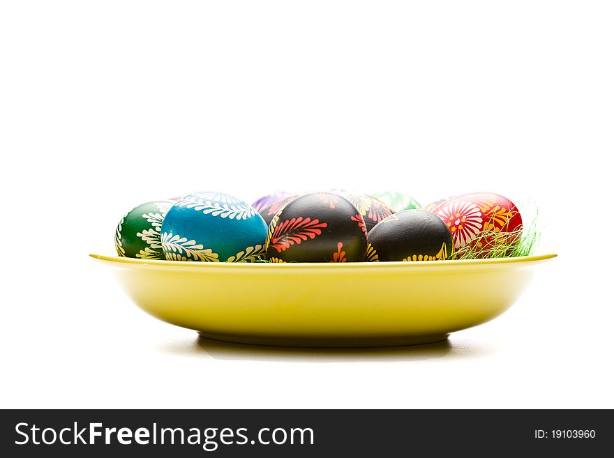 Painted Easter eggs on yellow plate. Painted Easter eggs on yellow plate