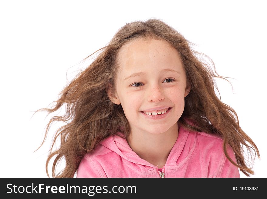 Young girl in pink top smiling with wind in her hair. Young girl in pink top smiling with wind in her hair