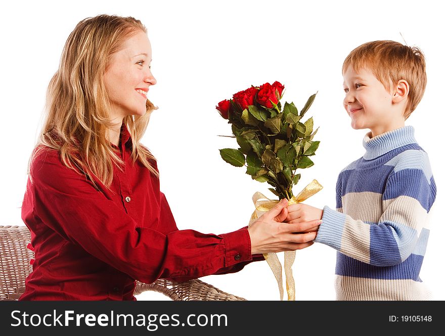 Charming beautiful young woman with a son and with the bouquet of red roses on a white background