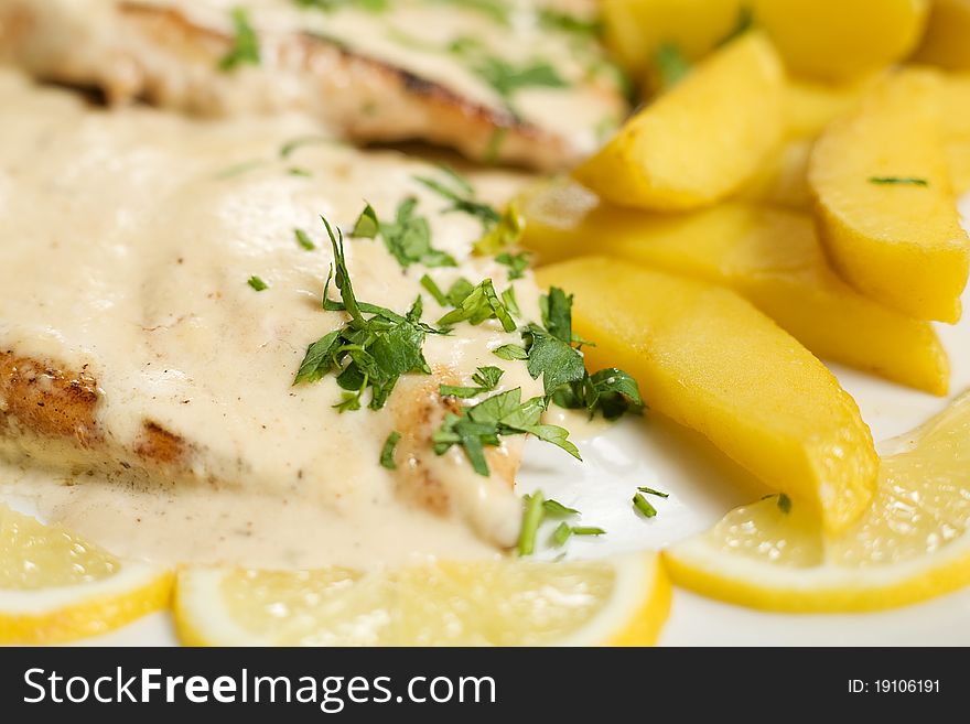 A plate of Chicken steak with sause, potatoes, close-up. A plate of Chicken steak with sause, potatoes, close-up