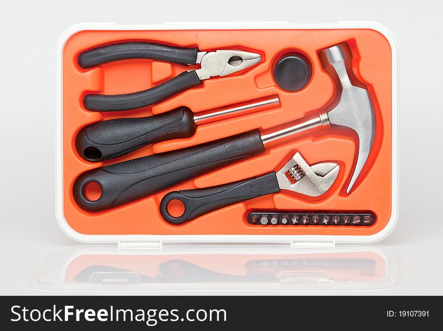 Tools mechanic in yellow toolbox on gray background