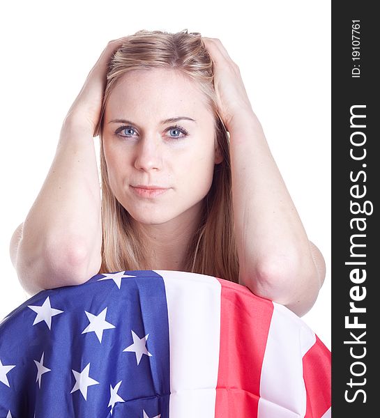 A hot girl pushes her hair back and poses with an American flag. A hot girl pushes her hair back and poses with an American flag.