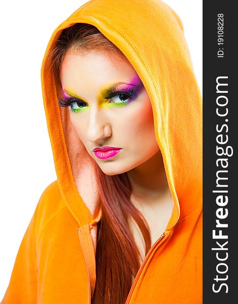 Beautiful girl with multi colored make up wearing orange hood on isolated white background. Beautiful girl with multi colored make up wearing orange hood on isolated white background