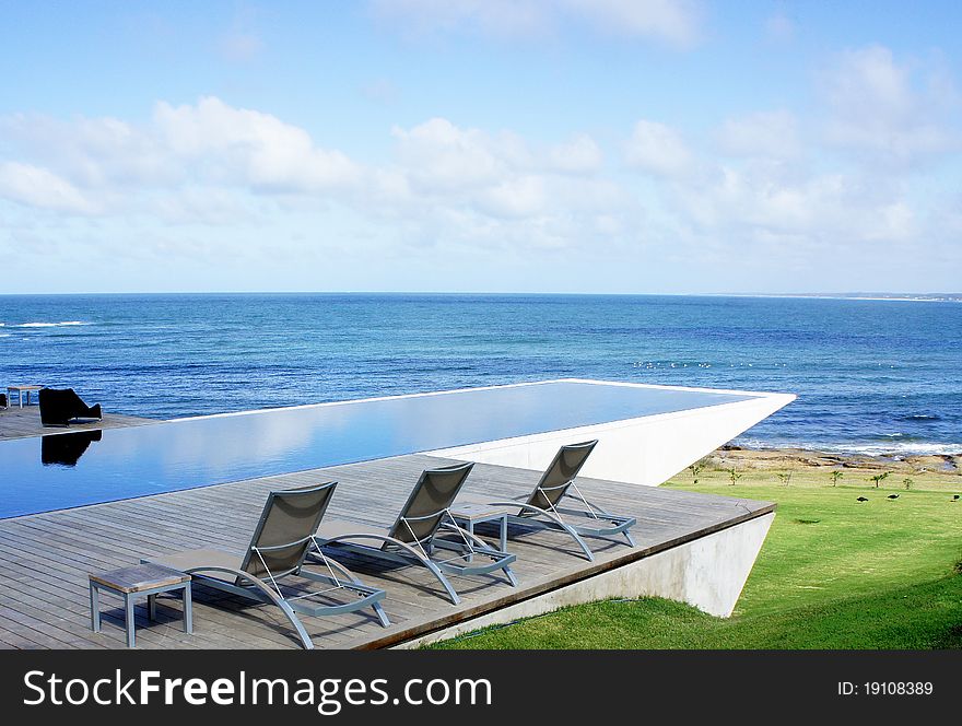 Pool in yard of beach house with ocean view