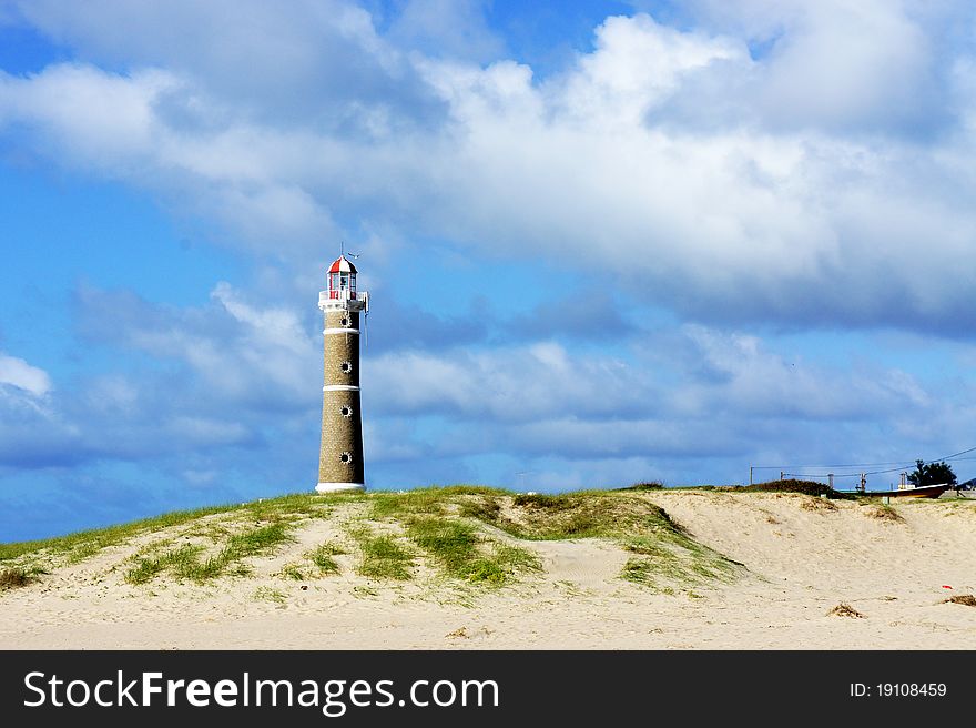 Lighthouse with building on dune in Uruguay