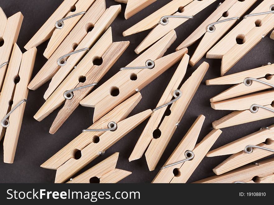 Wooden clothespins on a black background