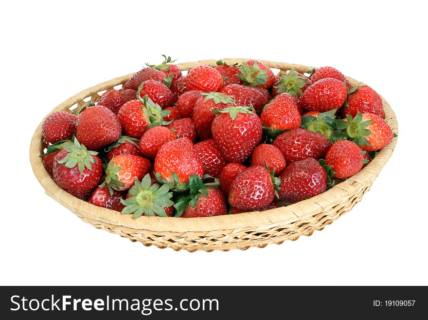 Fresh ripe strawberry in wicker bowl isolated over white background