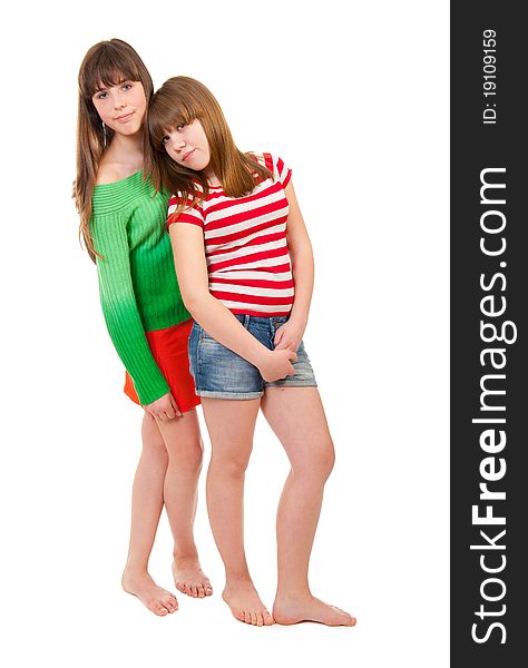 Full-length portrait of two girls, barefoot on a white background