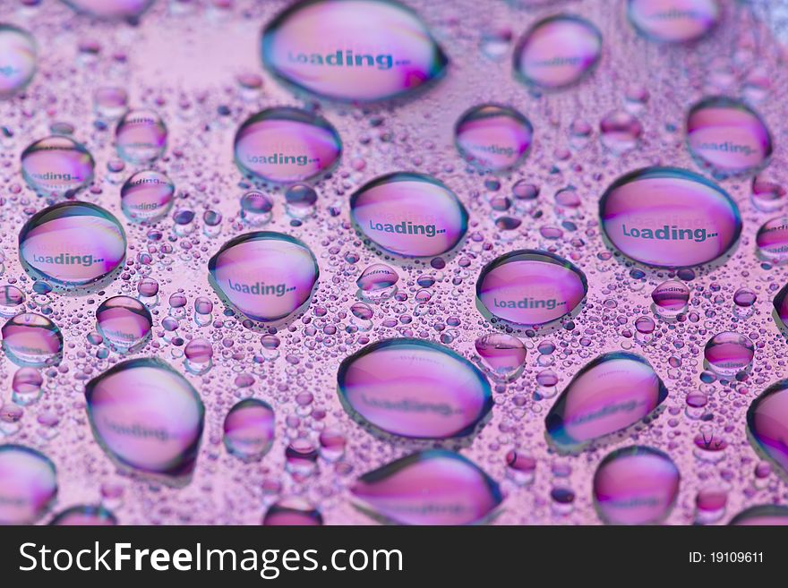 The word Loading... in water drops. Close-up of studo shot.