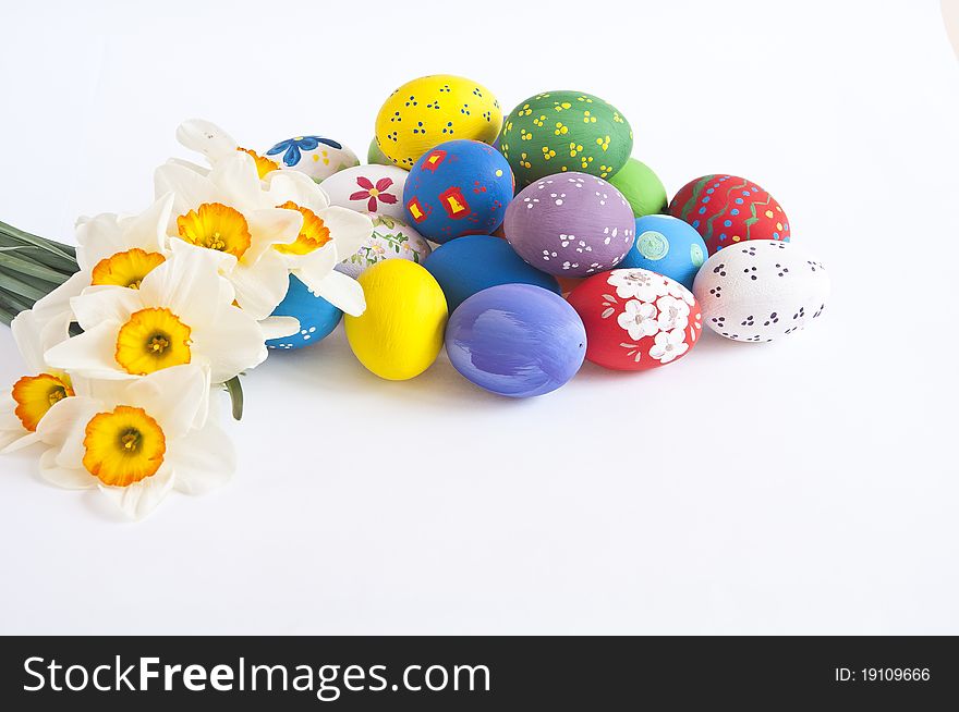 Painted easter eggs with various decoration photographed on white background with Narcissus. Painted easter eggs with various decoration photographed on white background with Narcissus