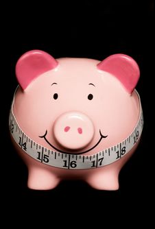 Piggy Bank With Tape Measure Stock Photos