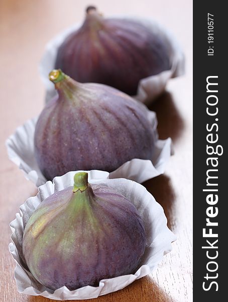 The fresh figs on the wooden background. The fresh figs on the wooden background