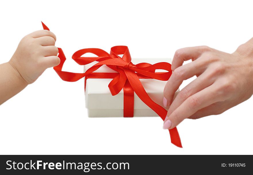 Child and woman hands opening the present