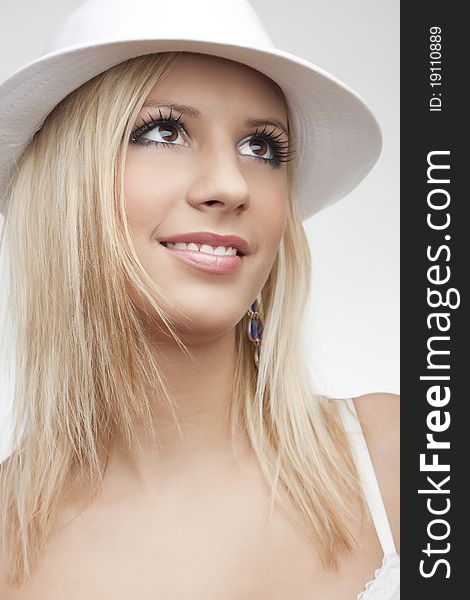 Beautiful smile blond girl in white hat