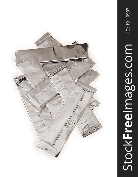 Several chewing gums wrapped in silver paper, isolated on white background