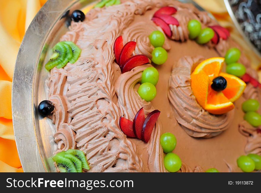 Delicious and healthy chocolate fruit cake coated with chocolate cream. Delicious and healthy chocolate fruit cake coated with chocolate cream.