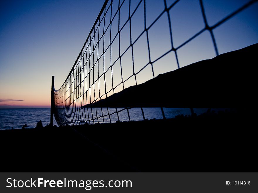 Volleyball net on Croatian beach with sea in background. Volleyball net on Croatian beach with sea in background