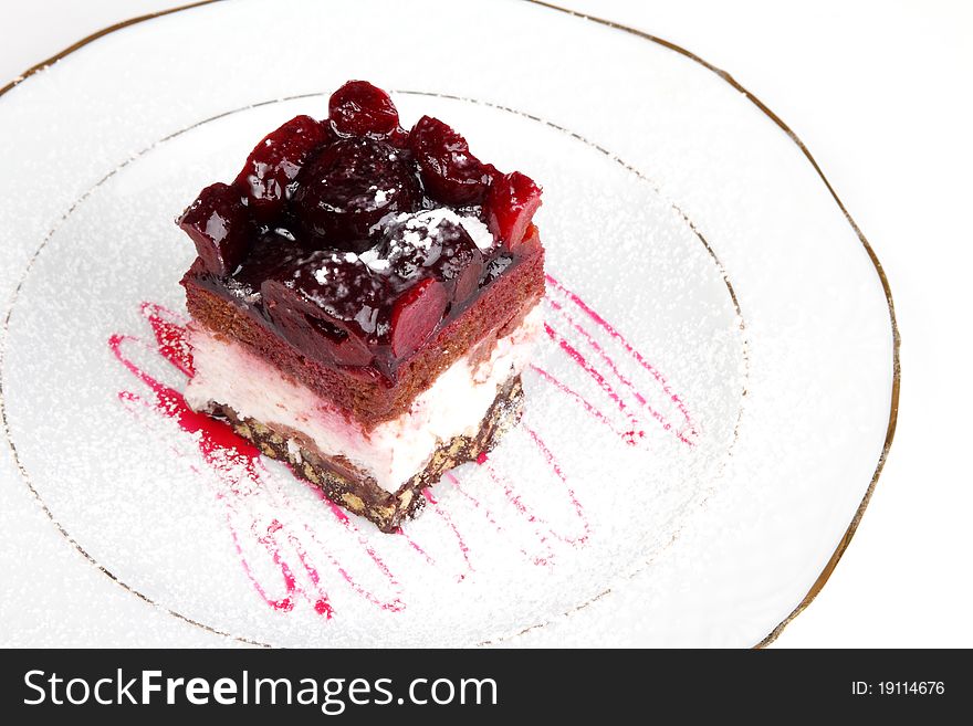 Slice of a biscuit pie with a cherry on a white plate