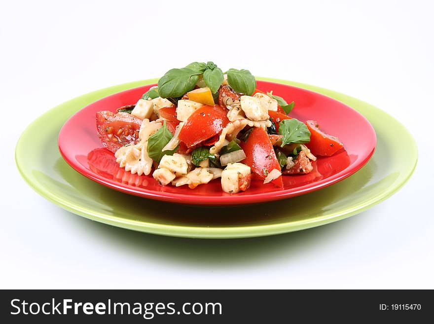 Salad - made of farfalle pasta, tomato, salami, bell pepper and mozzarella, decorated with basil. Salad - made of farfalle pasta, tomato, salami, bell pepper and mozzarella, decorated with basil