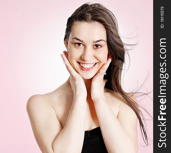 Portrait of a beautiful girl over pink background