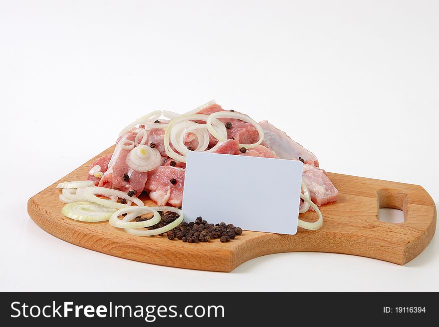 Raw meat, spices and plastic card on wood board. Raw meat, spices and plastic card on wood board