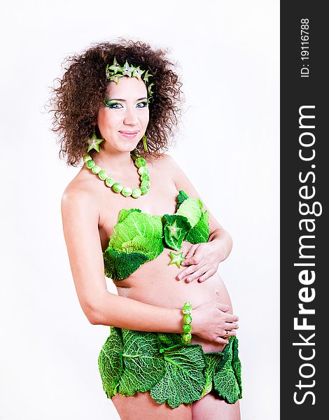 Beautiful pregnant young woman dressed in cabbage