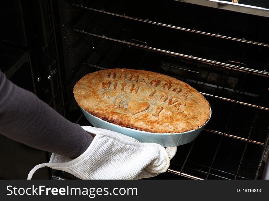 A home made pie with letters on. A home made pie with letters on.