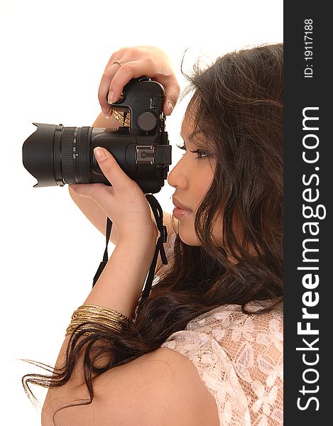 Young pretty Asian woman taking pictures with her camera, standing in the studio for white background. Young pretty Asian woman taking pictures with her camera, standing in the studio for white background.