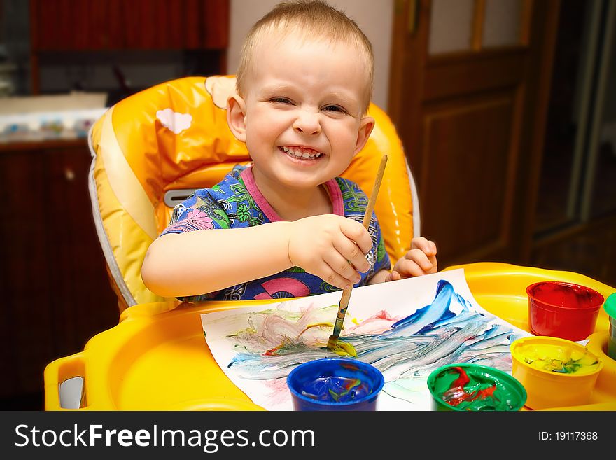 Little boy draws a colorful paints and brushes. Little boy draws a colorful paints and brushes