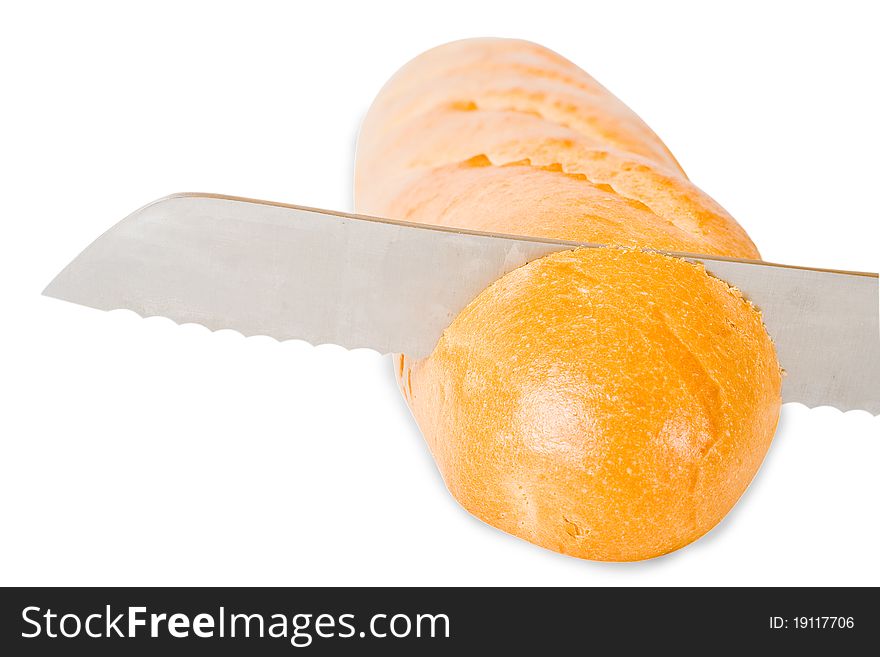 The grain knife cuts the French baguet. The grain knife cuts the French baguet