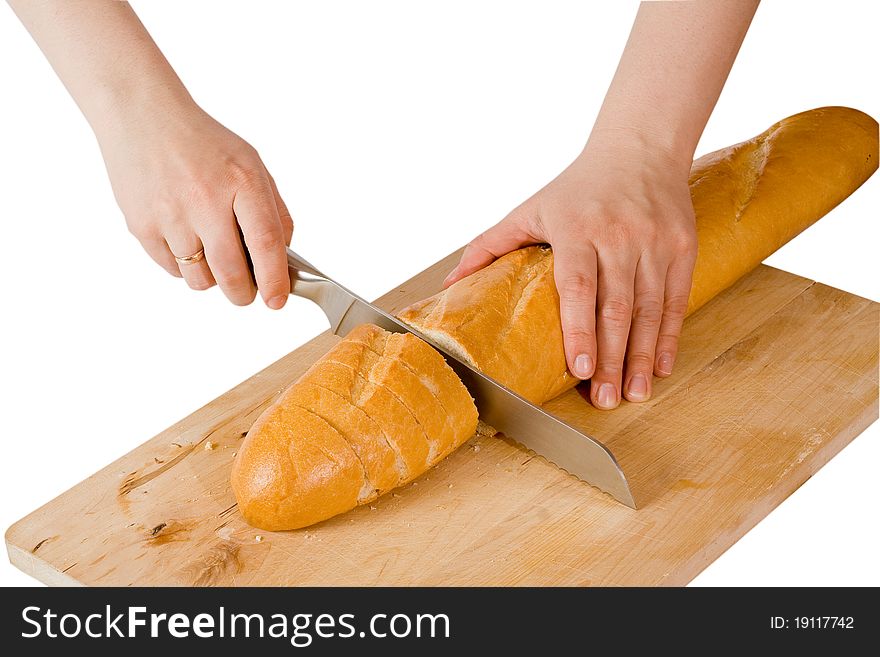 Hands cut the French baguet a knife. Hands cut the French baguet a knife