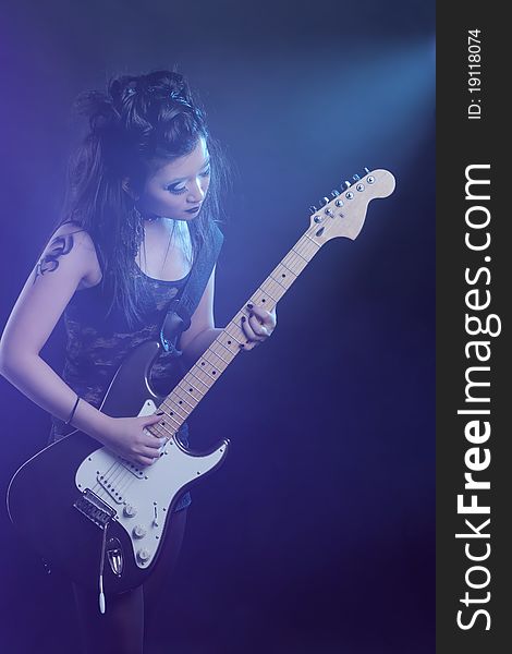 Woman rock star portrait with guitar