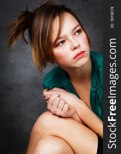 Girl in green blouse with a gray background