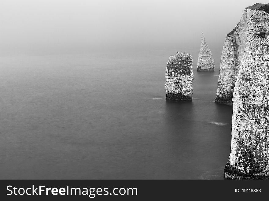 A long exposure of some chalk sea stacks off the Jurassic Coast in Dorset. A grey and overcast day led to black and white processing. A long exposure of some chalk sea stacks off the Jurassic Coast in Dorset. A grey and overcast day led to black and white processing.