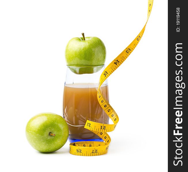 Still life with apple juice and a measuring  tape. Still life with apple juice and a measuring  tape