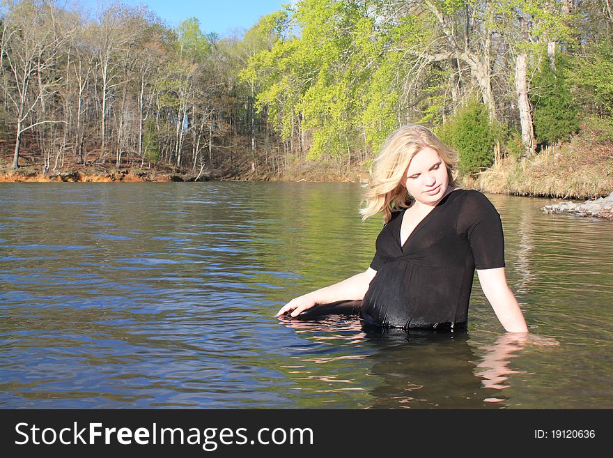 Beautiful pregnant woman standing in the lake. Beautiful pregnant woman standing in the lake.
