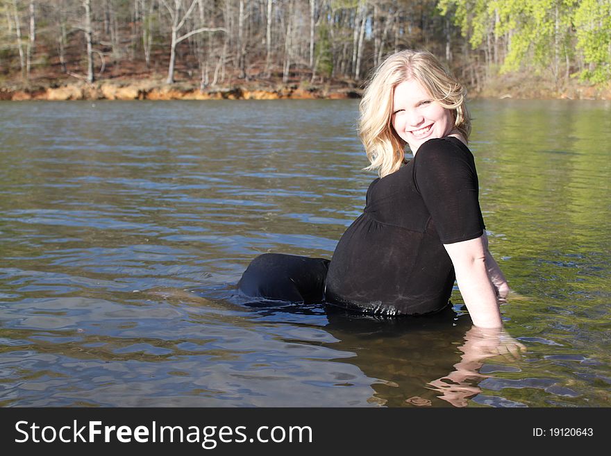 Beautiful pregnant water sitting in the water in a natural setting. Beautiful pregnant water sitting in the water in a natural setting.