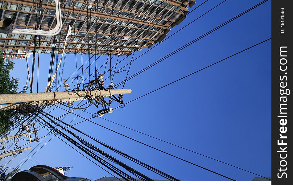 Under the blue sky, the wire extends far across the telegraph pole. Under the blue sky, the wire extends far across the telegraph pole.