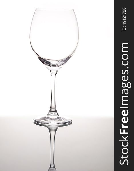 Empty wine glass with mirror reflection
