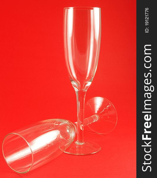 Two wine glasses over red background