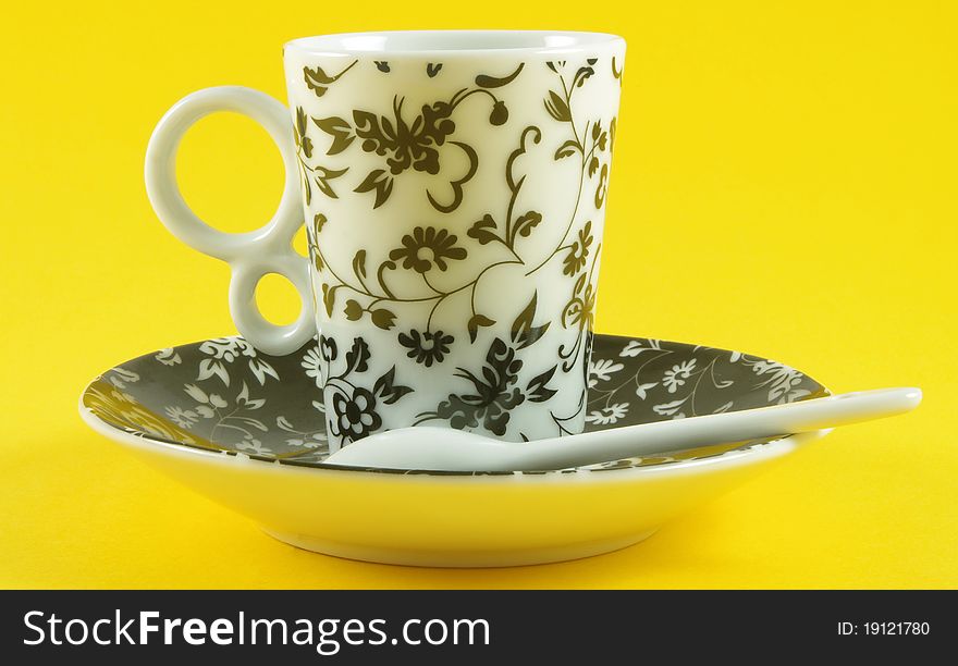 Cup and saucer isolated over yellow background. Cup and saucer isolated over yellow background