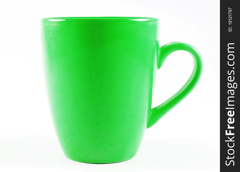 Old green mug isolated on white surface