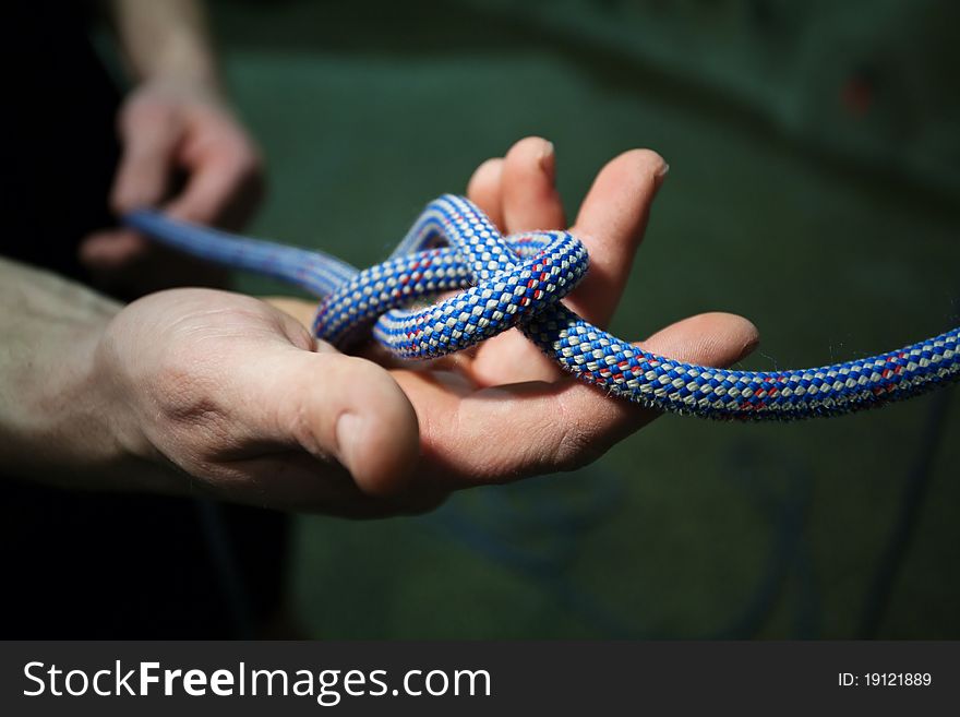 Hands holding and tying rope. Hands holding and tying rope