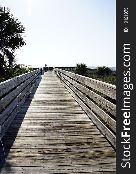 Picture of a wooden walkway leading to a beach. Picture of a wooden walkway leading to a beach