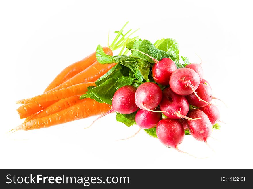 Fresh radishes and carrots on a white background