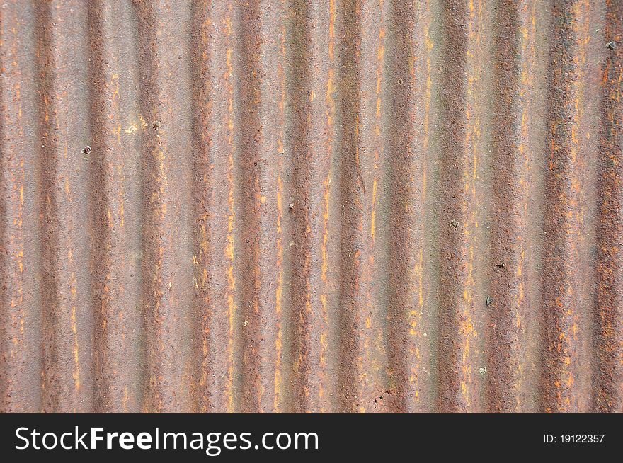 A piece of an old brown zinc background texture. A piece of an old brown zinc background texture